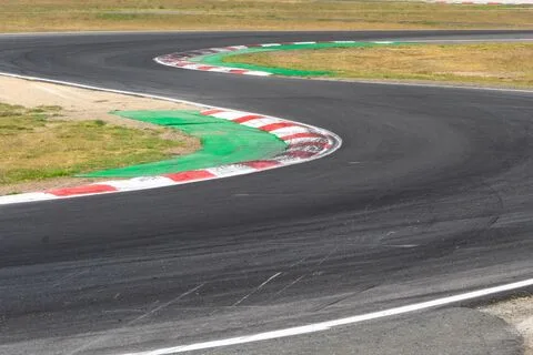 An empty bend with red and white kerbs and green run-off