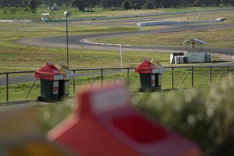 Trackside fire extinguisher stands looking out over the circuit